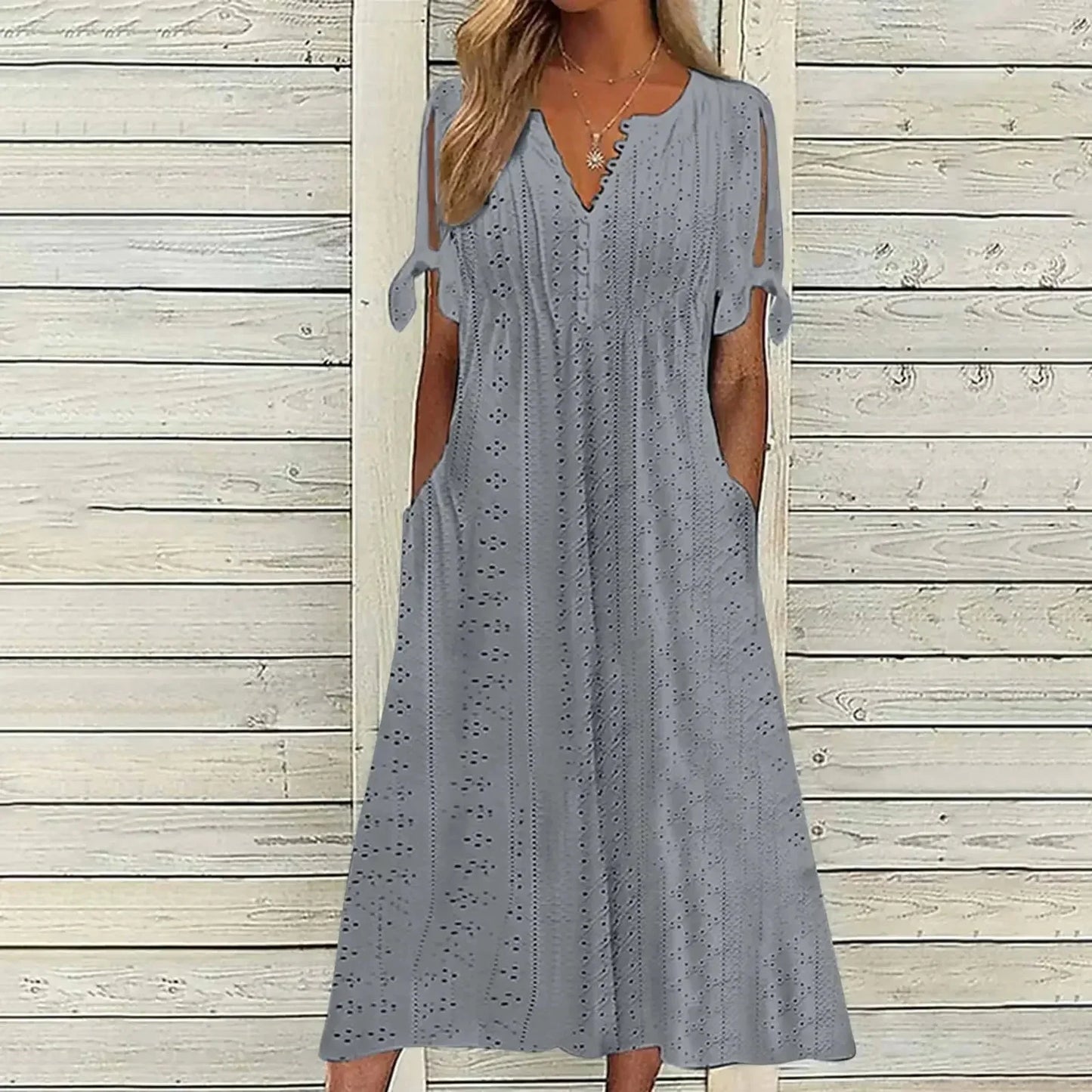 GRAY - A woman wearing a light blue midi-length eyelet dress with a scalloped V-neckline, split tie-sleeves, and side pockets, shown alongside color variations in pink, white, and mint green.