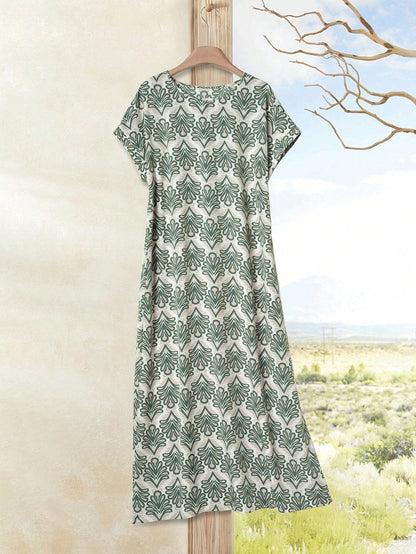 Dark Blue - A woman wearing a beige fine-knit maxi dress with cap sleeves and a crew neck, styled with gold jewelry and a woven clutch in a minimalist interior.