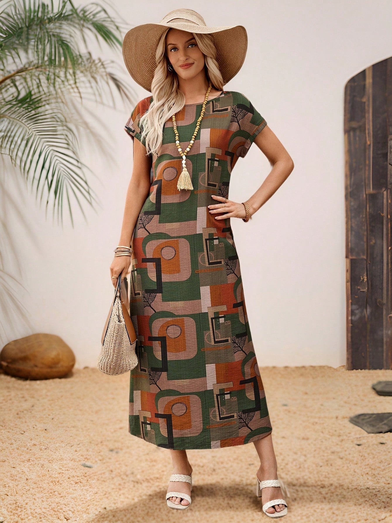 Dark Blue - A woman wearing a beige fine-knit maxi dress with cap sleeves and a crew neck, styled with gold jewelry and a woven clutch in a minimalist interior.