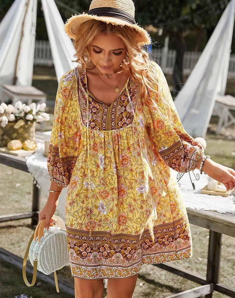 Yellow - Women's lightweight mini dress featuring a warm-toned floral border print, split tie neckline, and long blouson sleeves in a relaxed babydoll silhouette.
