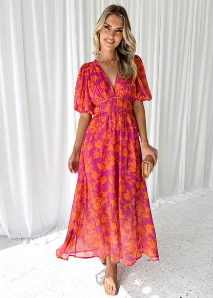 Orange - Bright pink and orange floral chiffon midi dress featuring a deep V-neckline, short puff sleeves, and a gathered waist, styled with a flowing skirt.