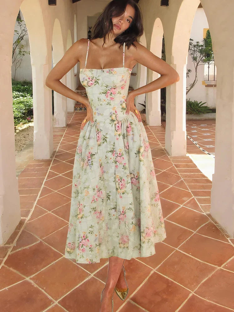 Green - Light green floral midi dress featuring a structured corset bodice, spaghetti straps, and a pleated full skirt.