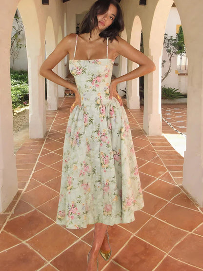 Green - Light green floral midi dress featuring a structured corset bodice, spaghetti straps, and a pleated full skirt.