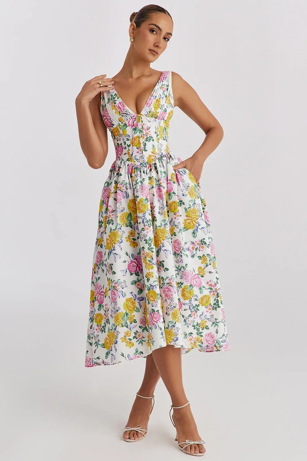Yellow - Woman wearing a white midi dress with yellow and pink floral print, featuring a corset-style bodice and a full gathered skirt.
