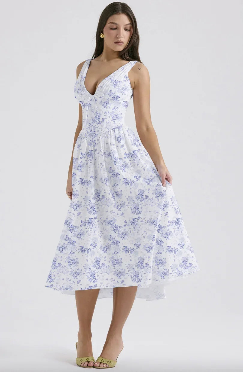 Blue - Woman wearing a white midi dress with yellow and pink floral print, featuring a corset-style bodice and a full gathered skirt.