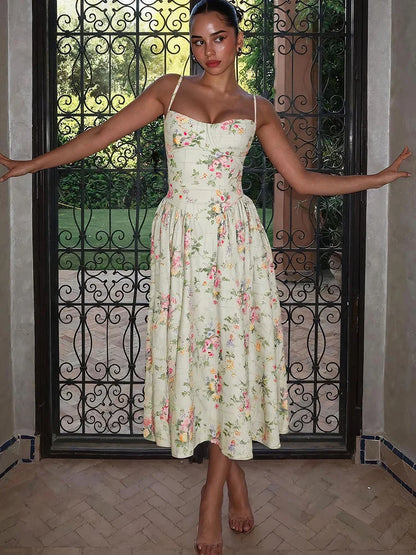 Green - Light green floral midi dress featuring a structured corset bodice, spaghetti straps, and a pleated full skirt.