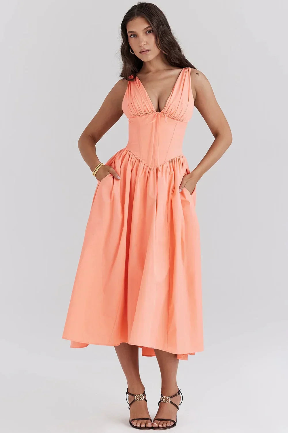 Peach - Woman wearing a white midi dress with yellow and pink floral print, featuring a corset-style bodice and a full gathered skirt.