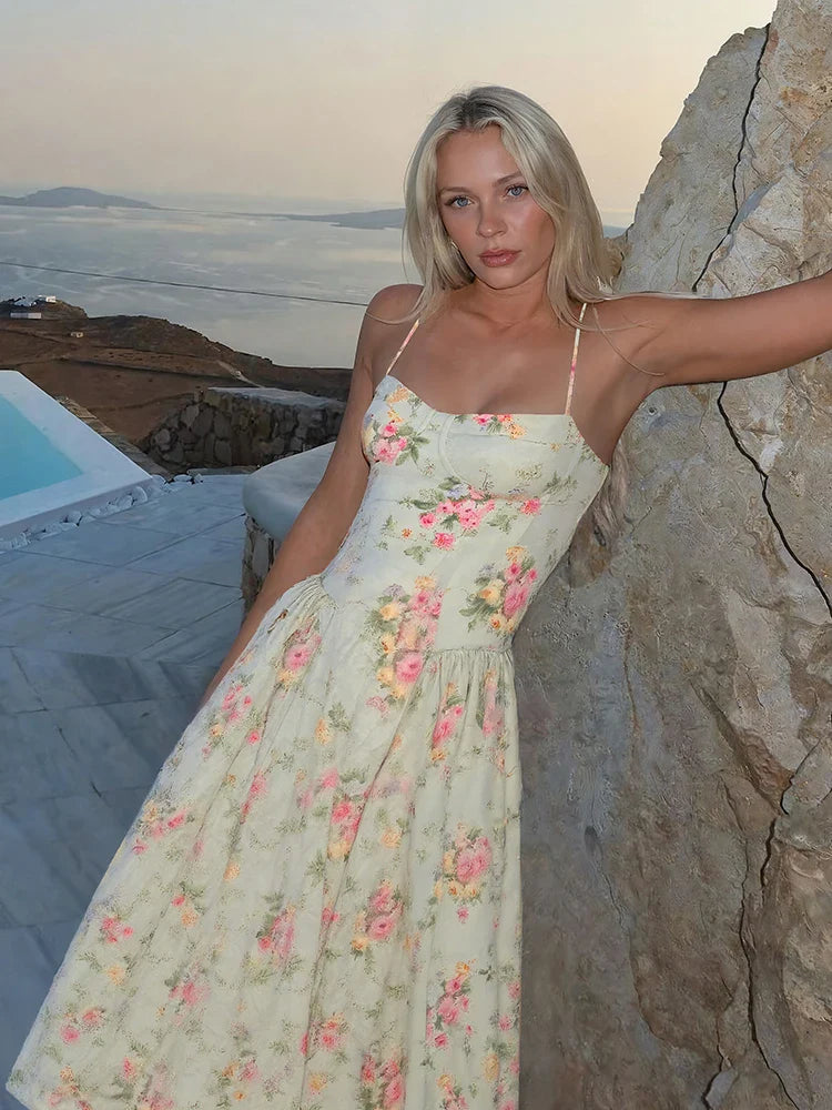 Green - Light green floral midi dress featuring a structured corset bodice, spaghetti straps, and a pleated full skirt.