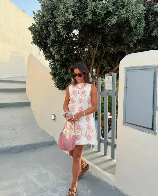 Pink - Sleeveless white A-line shift mini dress featuring large pink and gold embroidered floral motifs and a high neckline.