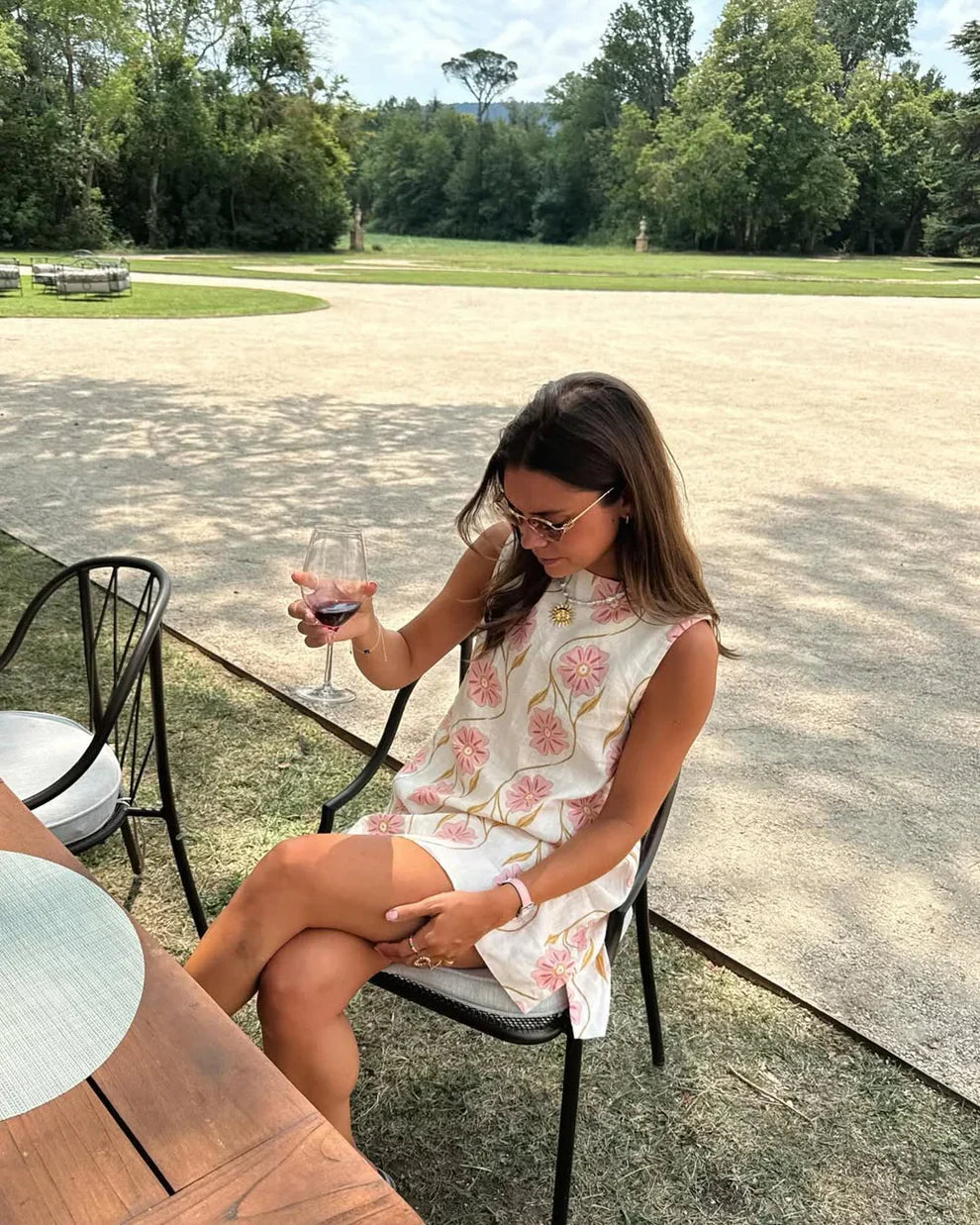 Pink - Sleeveless white A-line shift mini dress featuring large pink and gold embroidered floral motifs and a high neckline.