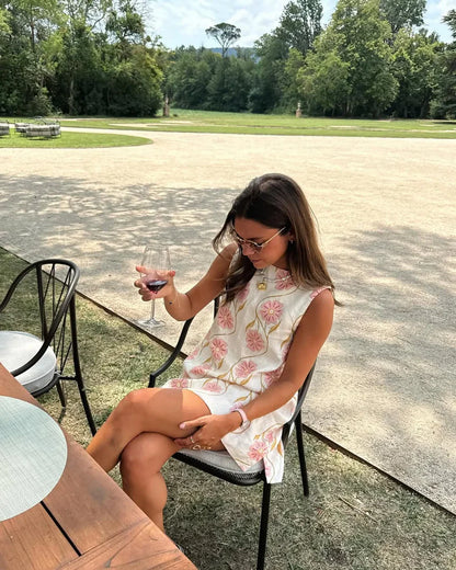 Pink - Sleeveless white A-line shift mini dress featuring large pink and gold embroidered floral motifs and a high neckline.