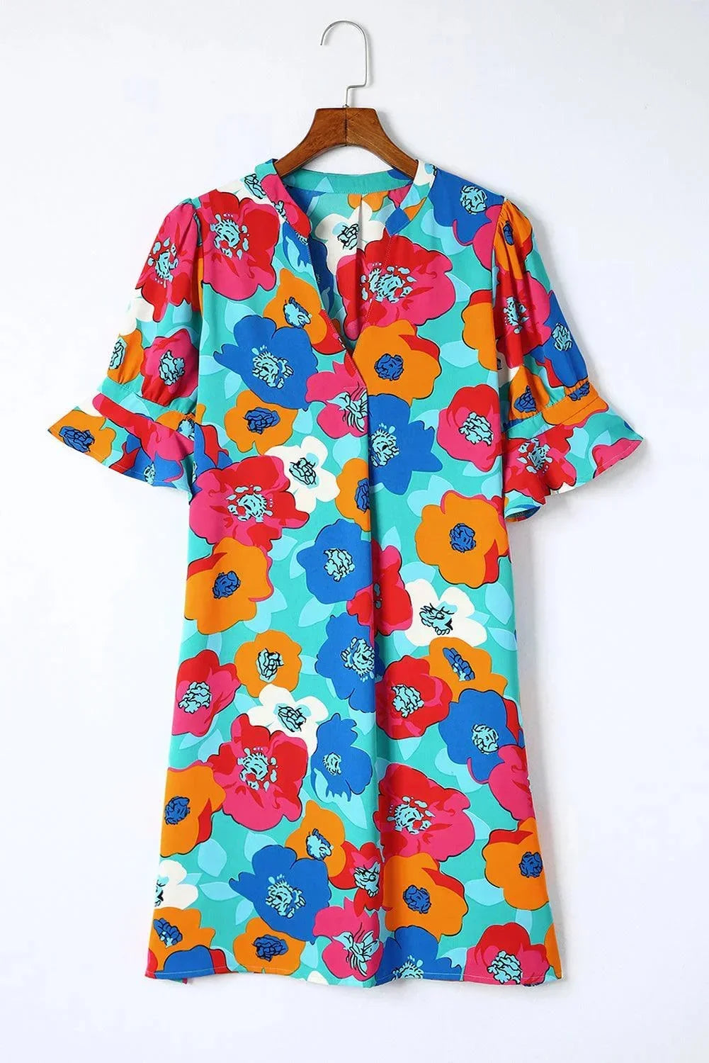 Orange - Woman wearing a vibrant teal mini shift dress with large abstract pink, orange, and blue floral print, featuring a split neckline and flutter sleeves.