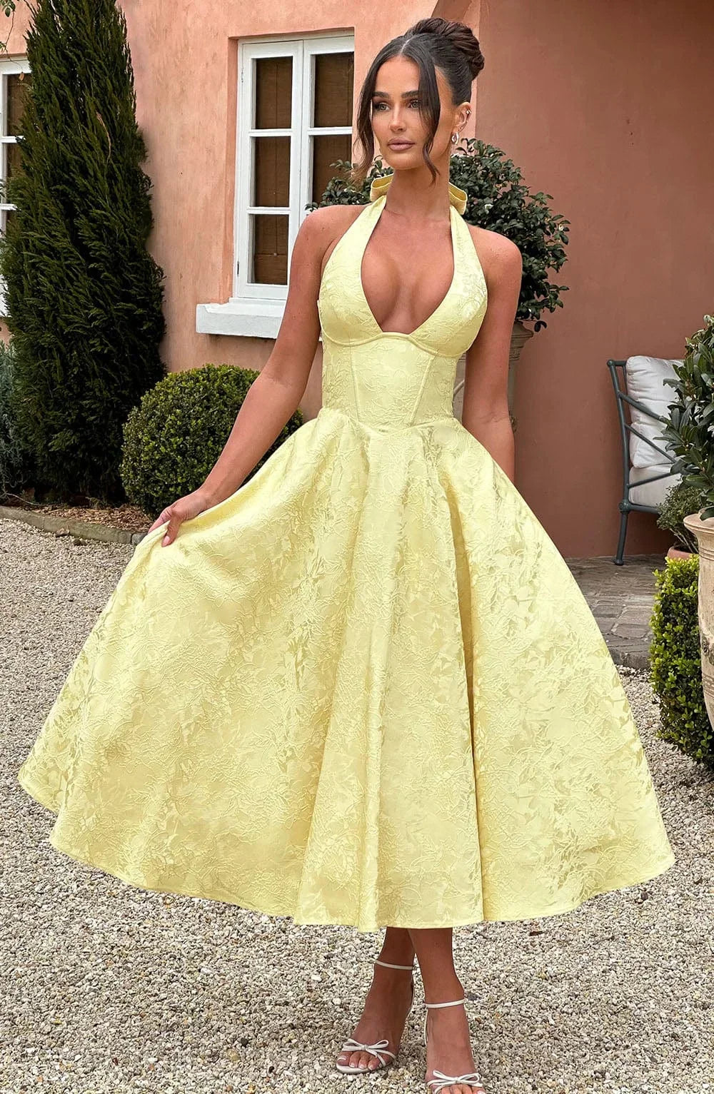 Yellow - Pale yellow floral jacquard midi dress featuring a plunging halter neckline, structured seamed bodice, and a full A-line skirt.