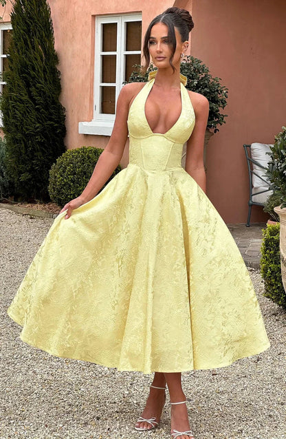 Yellow - Pale yellow floral jacquard midi dress featuring a plunging halter neckline, structured seamed bodice, and a full A-line skirt.