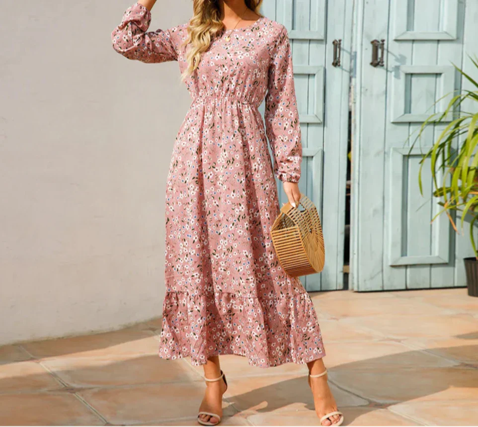Woman wearing a long sleeve floral midi dress with a cinched waist and tiered hem
