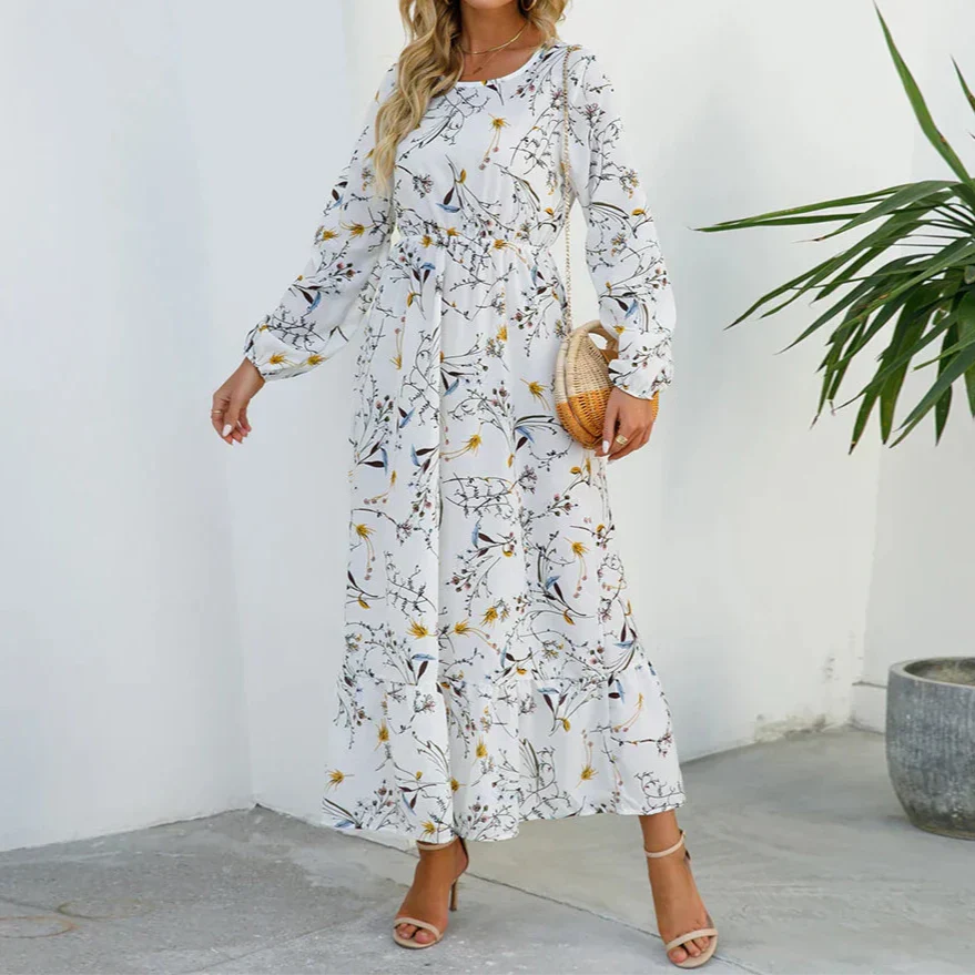 White - Woman wearing a long sleeve floral midi dress with a cinched waist and tiered hem