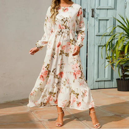 Violet (Almost sold out) - Woman wearing a long sleeve floral midi dress with a cinched waist and tiered hem
