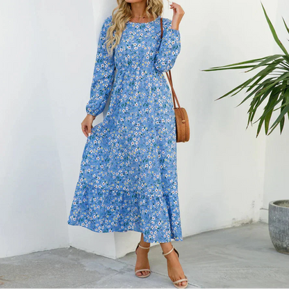 Blue - Woman wearing a long sleeve floral midi dress with a cinched waist and tiered hem
