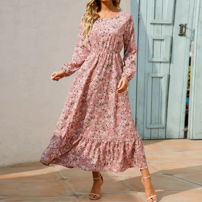 Pink (Almost sold out) - Woman wearing a long sleeve floral midi dress with a cinched waist and tiered hem