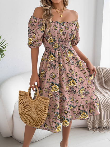 Pink - Woman wearing a floral off-shoulder midi dress with puff sleeves, a smocked waist, and a ruffle hem, holding a woven straw bag