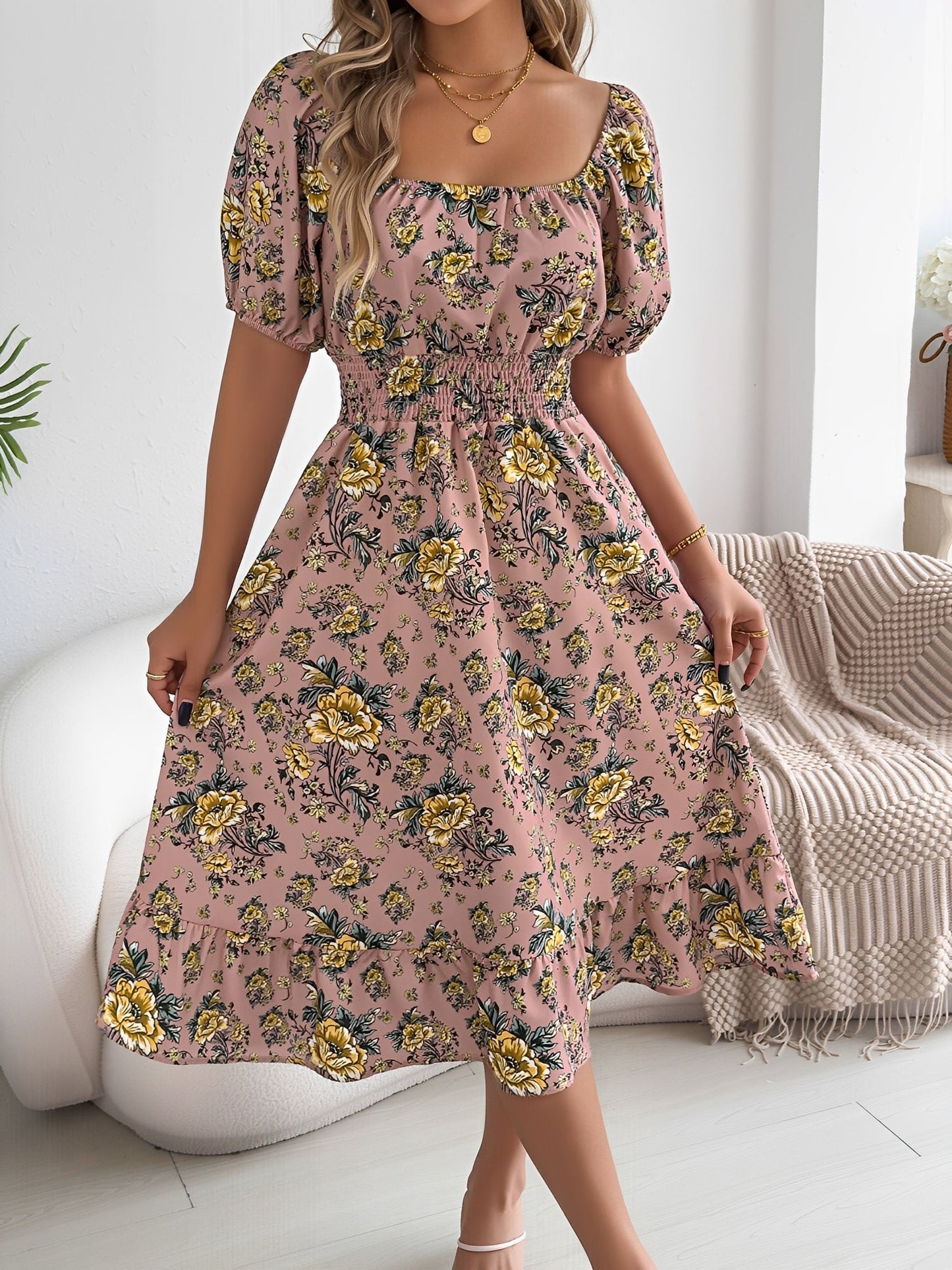 Pink - Woman wearing a floral off-shoulder midi dress with puff sleeves, a smocked waist, and a ruffle hem, holding a woven straw bag