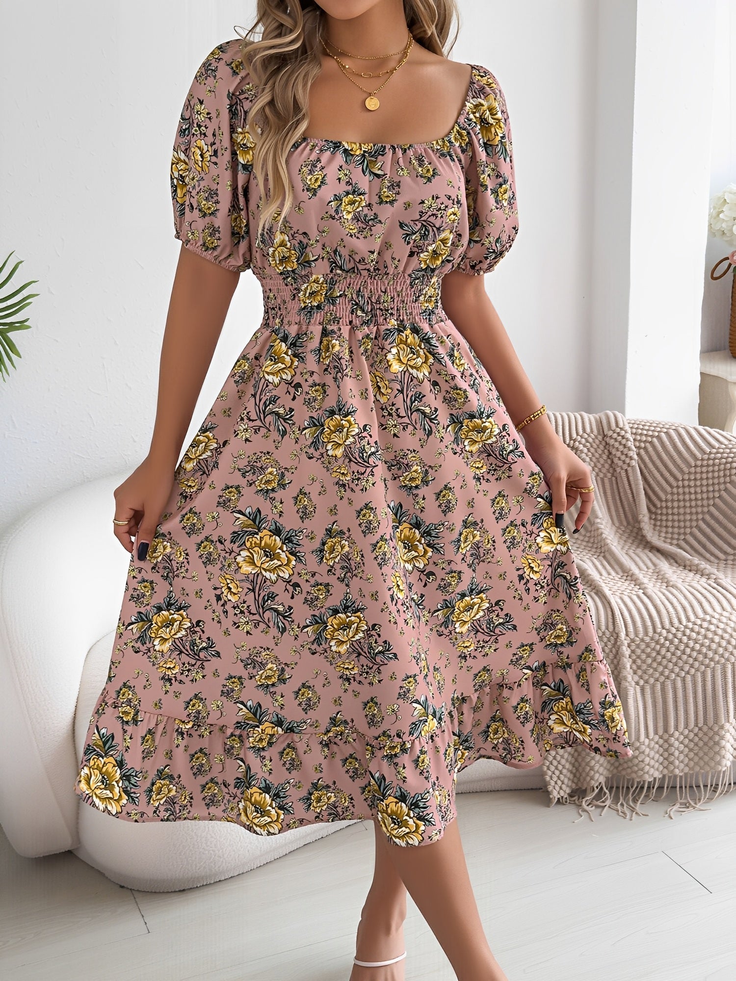 Pink - Woman wearing a floral off-shoulder midi dress with puff sleeves, a smocked waist, and a ruffle hem, holding a woven straw bag