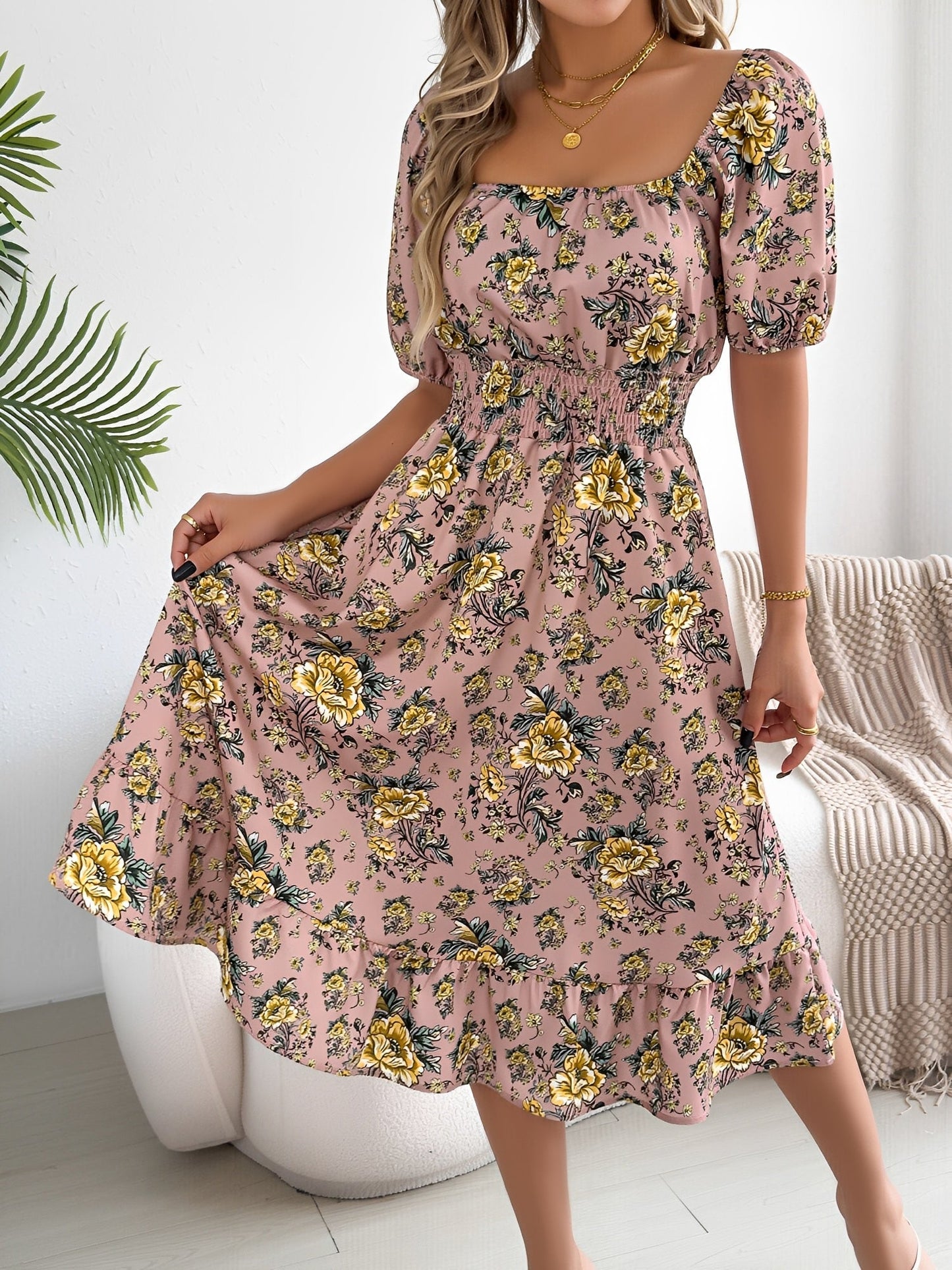 Pink - Woman wearing a floral off-shoulder midi dress with puff sleeves, a smocked waist, and a ruffle hem, holding a woven straw bag