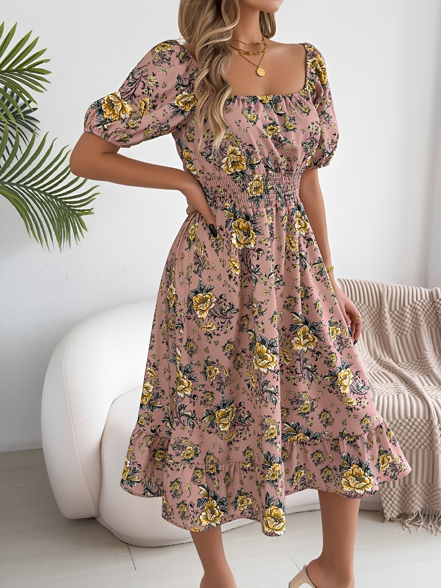 Pink - Woman wearing a floral off-shoulder midi dress with puff sleeves, a smocked waist, and a ruffle hem, holding a woven straw bag