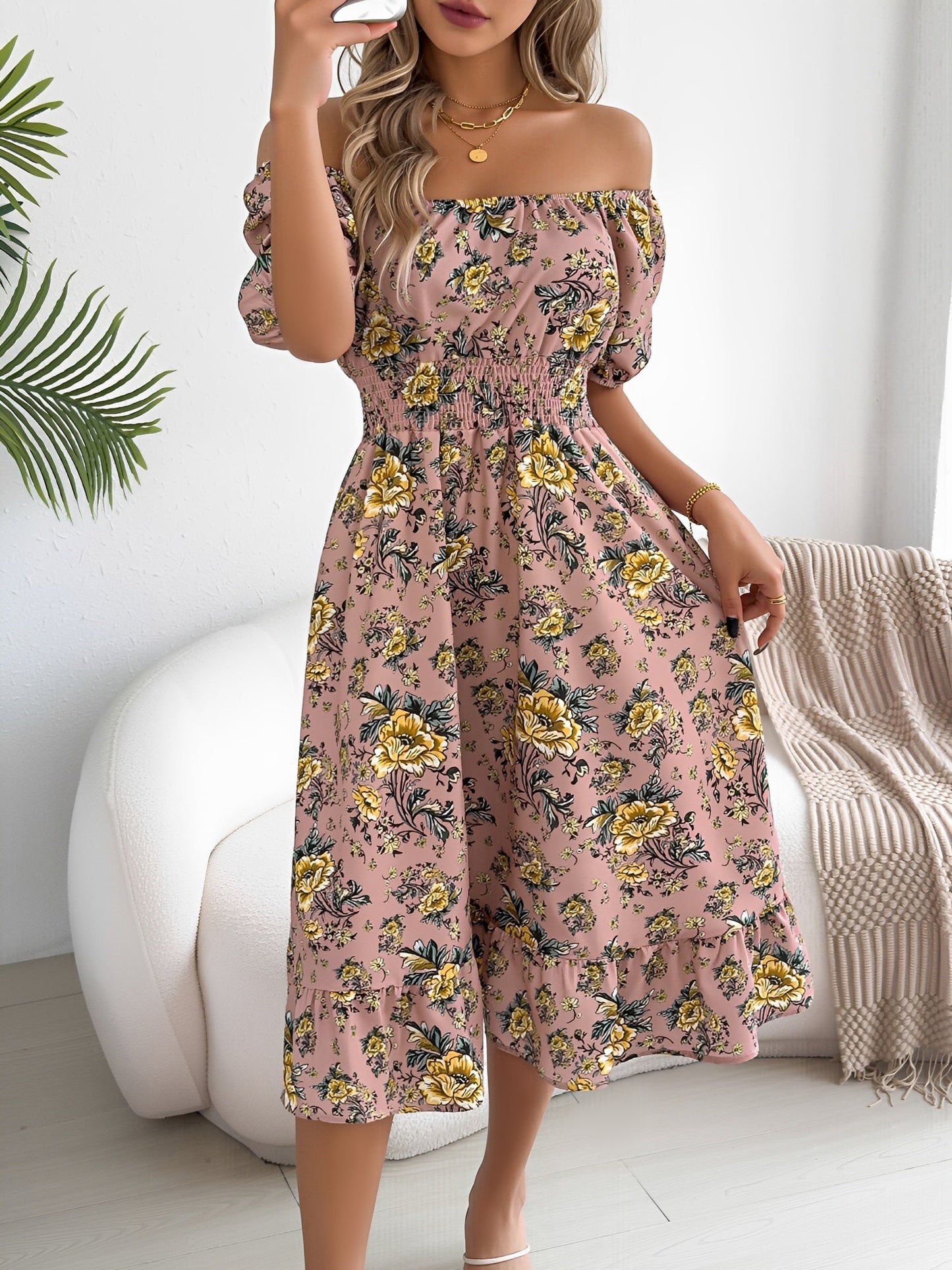 Pink - Woman wearing a floral off-shoulder midi dress with puff sleeves, a smocked waist, and a ruffle hem, holding a woven straw bag