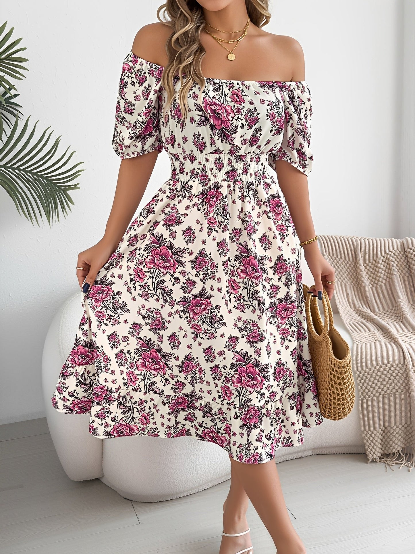 White - Woman wearing a floral off-shoulder midi dress with puff sleeves, a smocked waist, and a ruffle hem, holding a woven straw bag