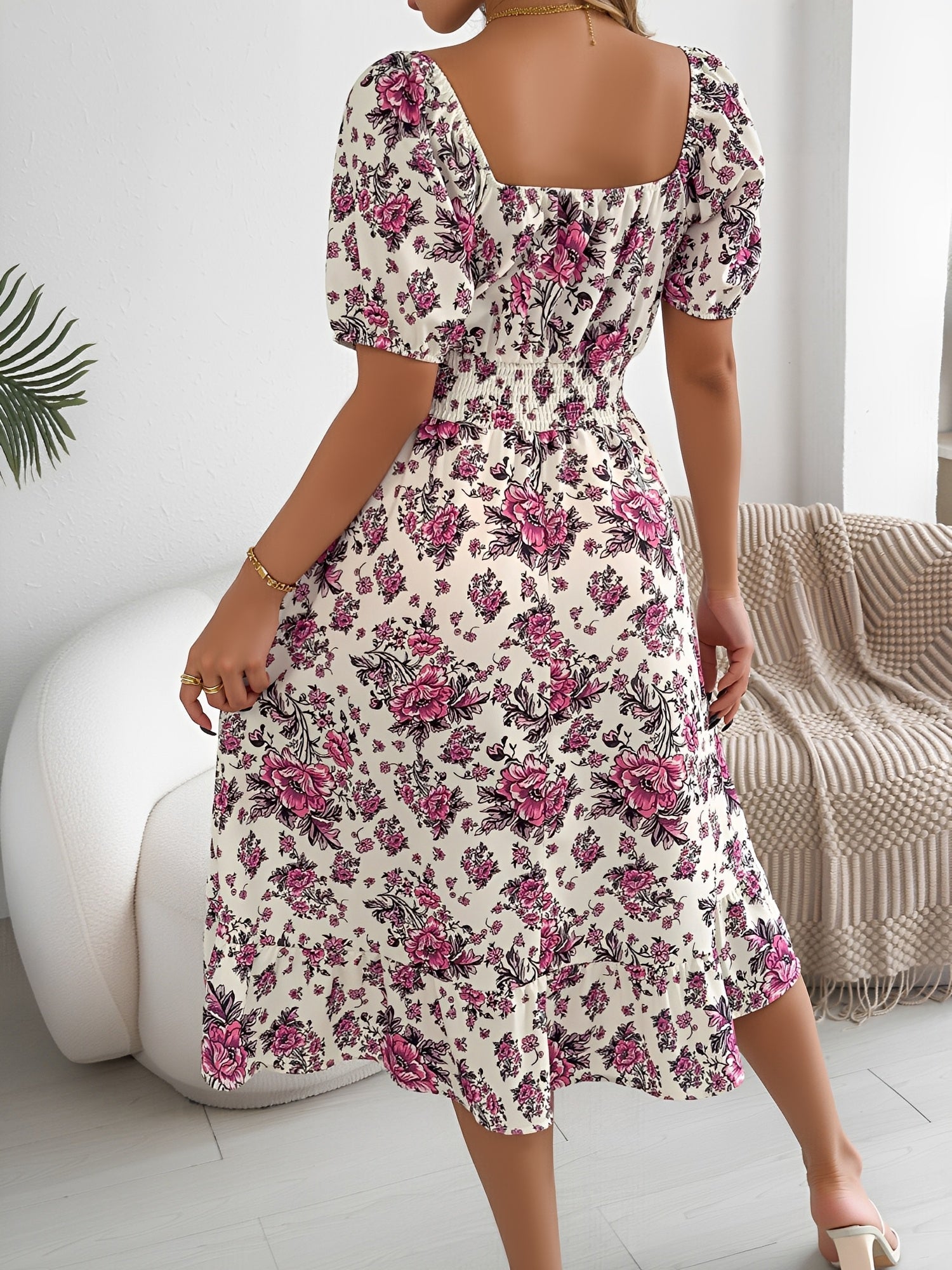 White - Woman wearing a floral off-shoulder midi dress with puff sleeves, a smocked waist, and a ruffle hem, holding a woven straw bag