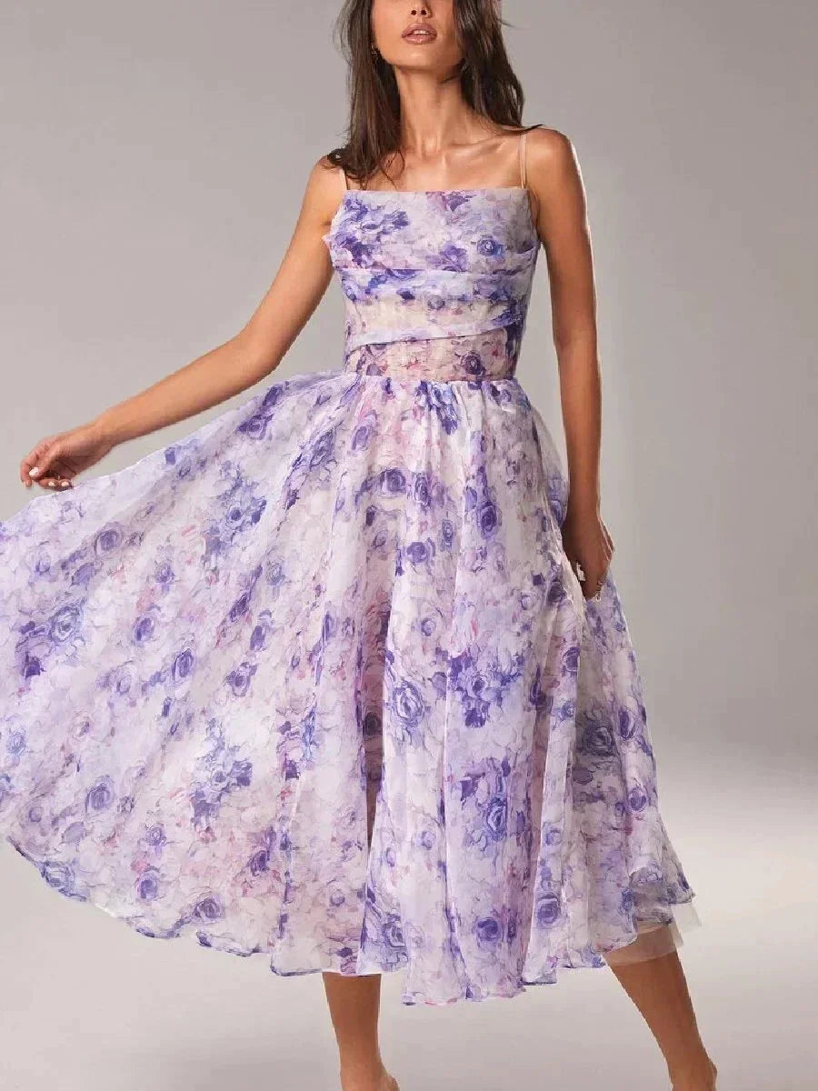 Purple - White midi dress with pink and green floral print, featuring a ruched bodice, spaghetti straps, and a full A-line skirt.