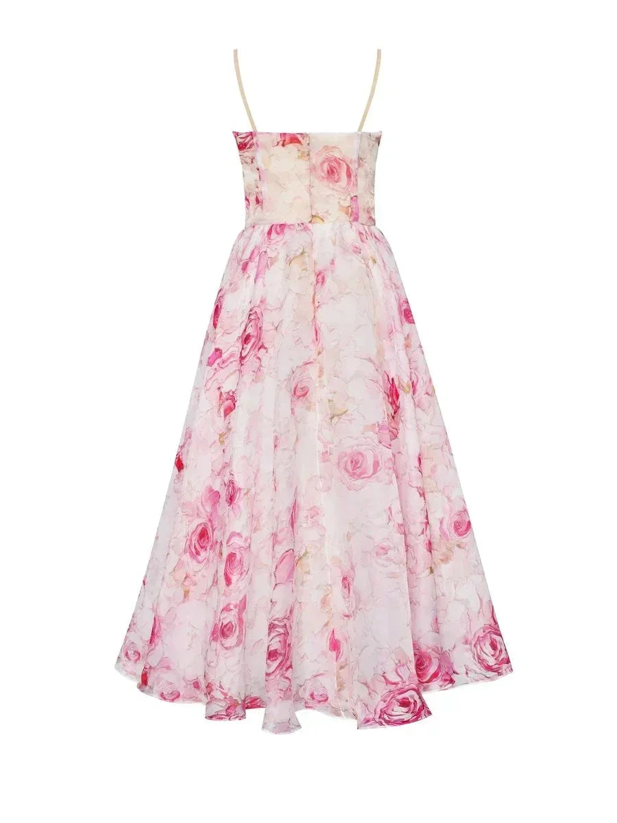 Pink - White midi dress with pink and green floral print, featuring a ruched bodice, spaghetti straps, and a full A-line skirt.