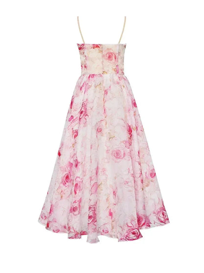 Pink - White midi dress with pink and green floral print, featuring a ruched bodice, spaghetti straps, and a full A-line skirt.