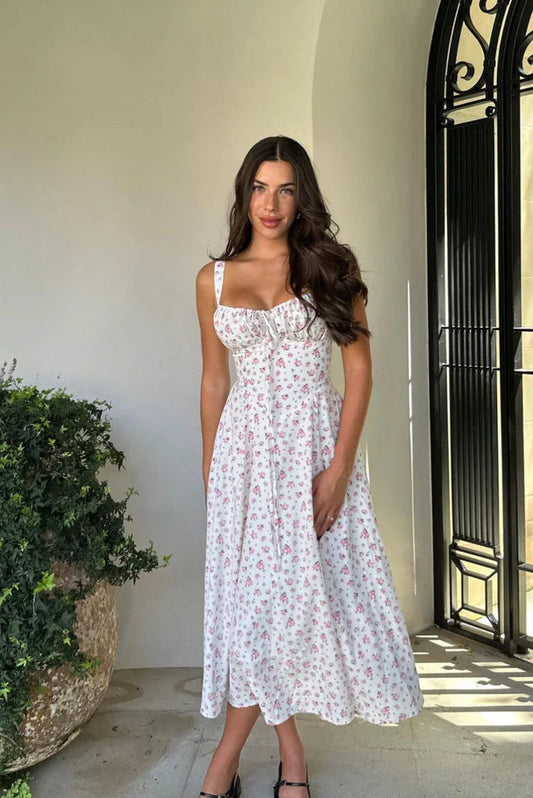 White - White midi dress with a pink floral print, featuring a ruched tie-front bust, wide shoulder straps, and a flowing A-line skirt.
