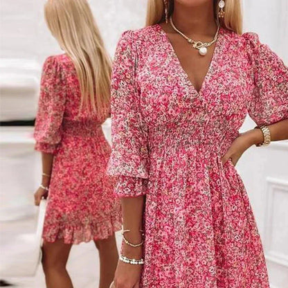 Pink - Woman wearing a pink floral mini dress with a V-neckline and smocked waist.