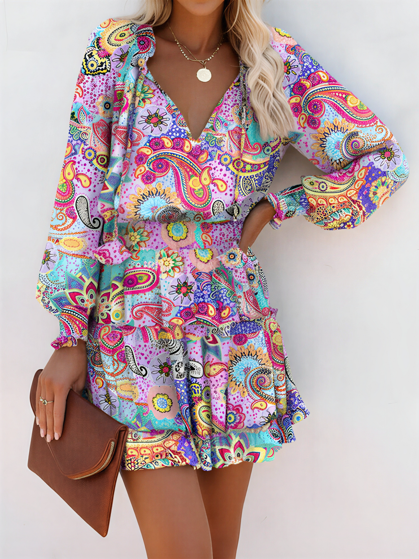 Light Purple - Woman wearing a dark mini dress with large bright floral print, featuring long sleeves, a smocked waist, and a tiered ruffle skirt
