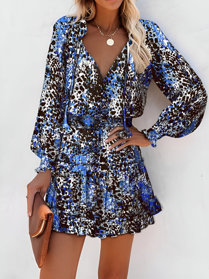 Blue - Woman wearing a dark mini dress with large bright floral print, featuring long sleeves, a smocked waist, and a tiered ruffle skirt