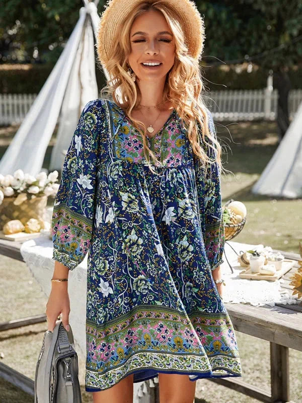 Dark blue - Pink bohemian floral print mini dress featuring a v-neckline with tie details, three-quarter blouson sleeves, and a relaxed shift silhouette with border print hem.