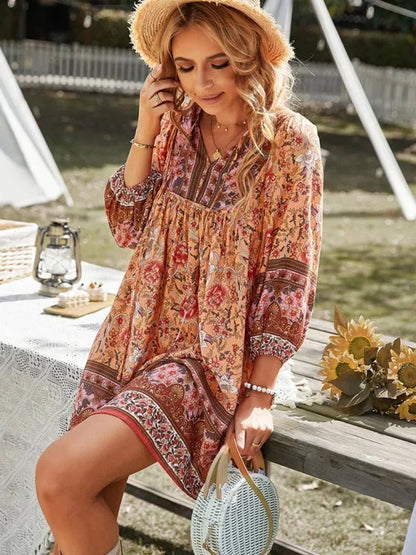 Dark blue - Pink bohemian floral print mini dress featuring a v-neckline with tie details, three-quarter blouson sleeves, and a relaxed shift silhouette with border print hem.
