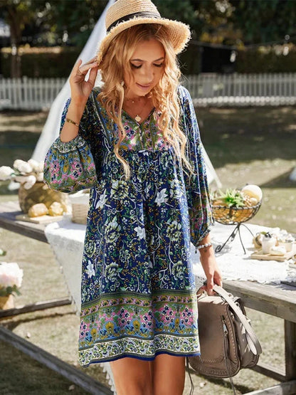 Dark blue - Pink bohemian floral print mini dress featuring a v-neckline with tie details, three-quarter blouson sleeves, and a relaxed shift silhouette with border print hem.