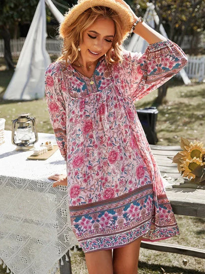 Pink - Pink bohemian floral print mini dress featuring a v-neckline with tie details, three-quarter blouson sleeves, and a relaxed shift silhouette with border print hem.