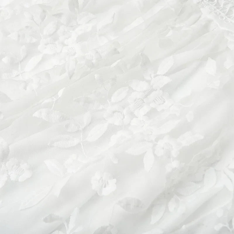 White - White floral appliqué tulle mini dress featuring a deep plunge neckline, crochet-trimmed waist, and a fluid A-line skirt.