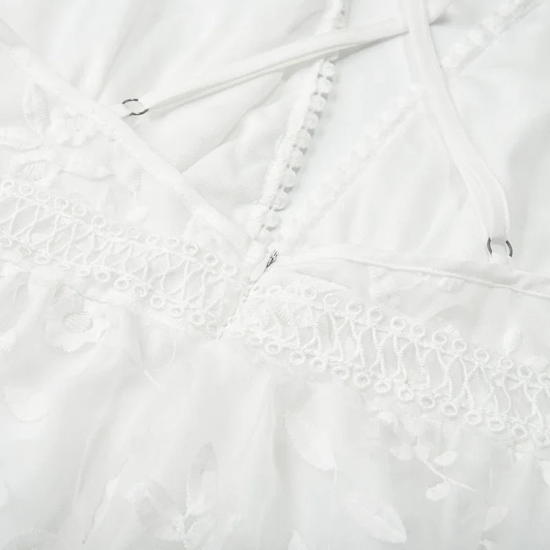White - White floral appliqué tulle mini dress featuring a deep plunge neckline, crochet-trimmed waist, and a fluid A-line skirt.
