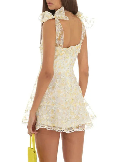 Light yellow - Pink and white floral tulle mini dress featuring a square neckline, tie-shoulder straps, and a scalloped hem.