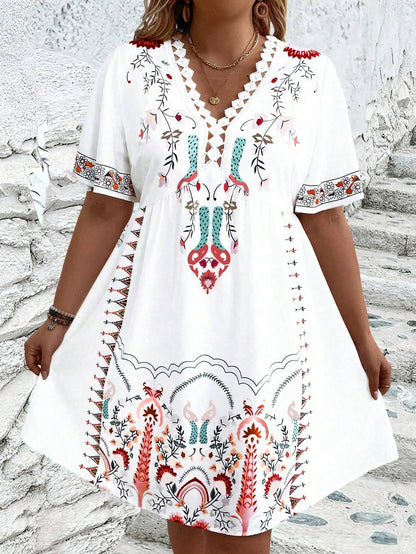 A woman wearing a white midi dress featuring a colorful folk-inspired floral print, a crochet-trimmed V-neckline, and short flutter sleeves, holding a woven straw clutch.