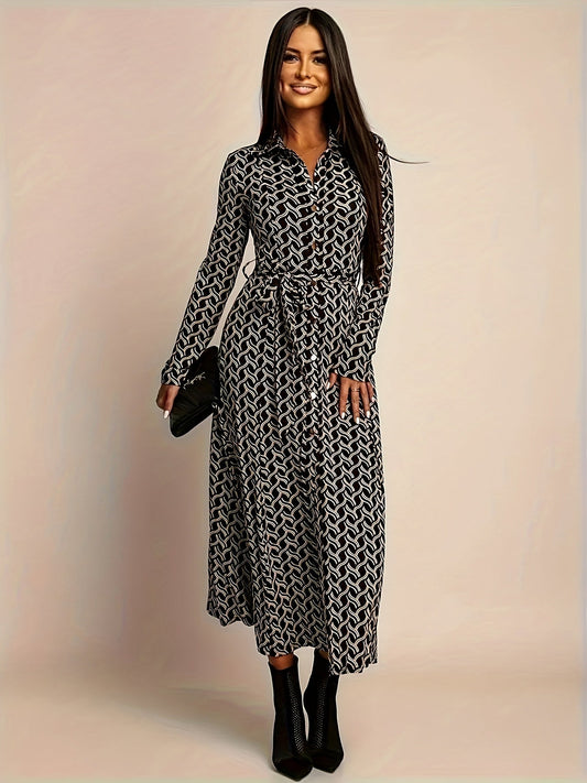 Woman wearing a black and white geometric print long-sleeve midi shirt dress with a waist belt.