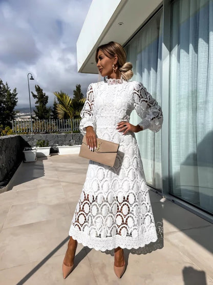 White - Light blush pink geometric crochet midi dress featuring a high scalloped mock neck, long balloon sleeves, banded waist, and partially lined A-line skirt.
