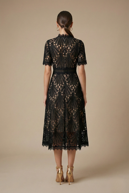 Black - Black geometric guipure lace midi dress featuring a high scalloped neckline, short sleeves, a banded waist, and an A-line skirt over a nude lining.