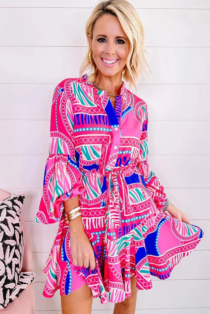 Pink - Bright pink and blue geometric scarf print mini dress featuring a collared v-neckline, long balloon sleeves, a drawstring waist, and a ruffled flounce hem.